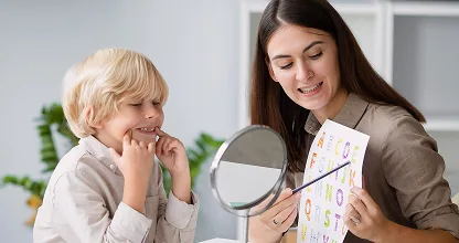 Child in a speech therapy session with a therapist
